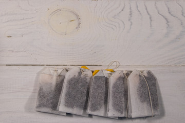 Tea bags on white wooden table. Top view