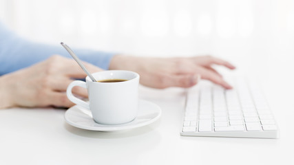 Work on a computer with a cup of coffee.
