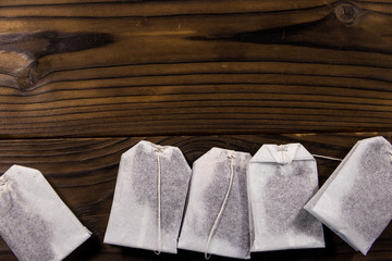 Tea bags on wooden table. Top view