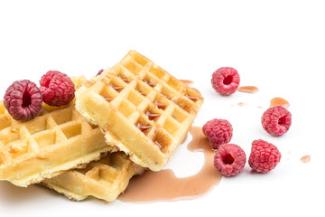 Traditional waffle (Belgian) with fresh red raspberries and syrup isolated on white background three sweet delicate and airy.