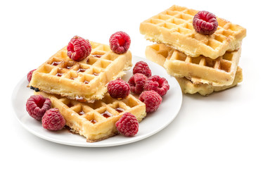Traditional waffle (Belgian) with fresh raspberries on a saucer and honey isolated on white background sweet delicate and airy delicious breakfast.