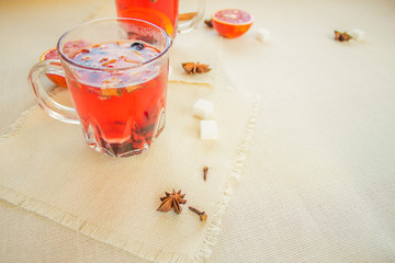 Tea made from dried fruit, seasoned with cinnamon cloves and anise seeds. There is an orange nearby
