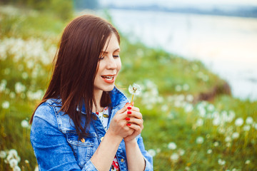 Woman among dandelions