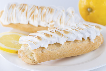Appetizing sweet dessert. Cake with cream in a white plate