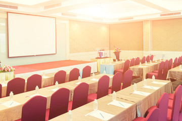 Conference Meeting Room , Row of  Chairs with Stage and Empty Screen for Business Meeting, Conference, Training Course, used as Template of The Elegant Design Office