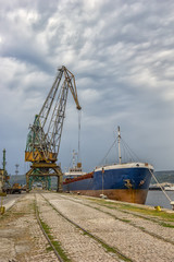 Loading raw materials in the warehouse on the trading ship  of the port city, Varna, Bulgaria