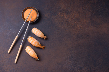 Sushi nigiri with shrimp and sauce with copy space