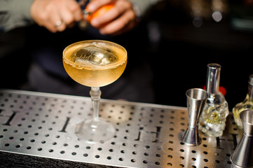 Barman making an alcoholic cocktail on the bar counter