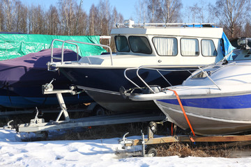 Winter boats parking - boats on a trailers