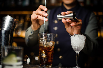 Bartender making a cocktail in a glass