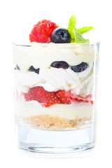Sweet tiramisu dessert with berries and ice-cream in a glass isolated on white background