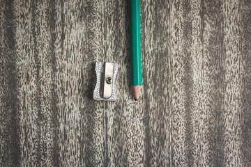 Wood texture pencil with sharpening shavings on black craft paper background
