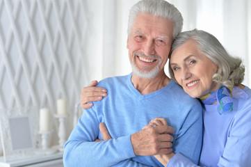 happy senior couple hugging  at home