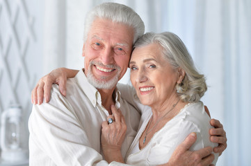 happy senior couple hugging  at home