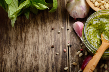 Top view of Pesto sauce and ingredients on wood table with copy-space