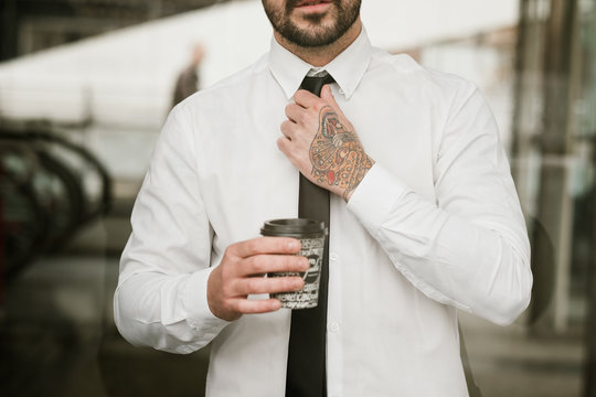 Crop man adjusting tie