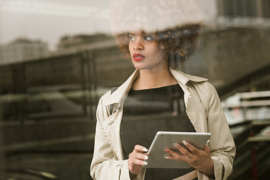 Attractive woman standing with tablet