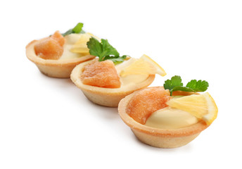 Delicious appetizers with cod caviar on white background