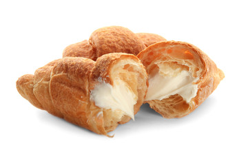 Tasty croissants with cream on white background