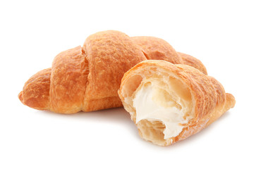 Tasty croissants with cream on white background
