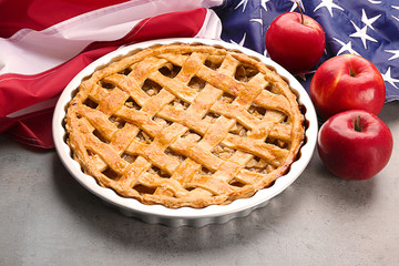 Delicious American apple pie with flag on table