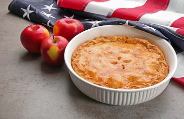 Delicious American apple pie with flag on table