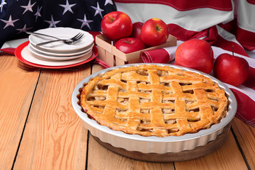 Delicious American apple pie on table against flag