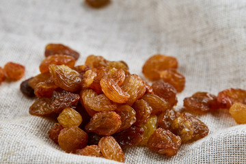 Top view close-up picture of dried apples on light cotton tablecloth, selective focus, macro