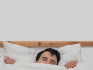 Fototapeta na wymiar caucasian male lying in blanket on bed