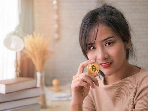 Asian Beautiful Young Business Executive Hold Golden Bitcoin Coin In Her Hand