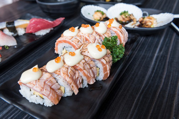 salmon rolls in black plate 