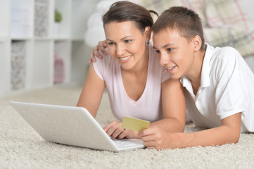 mother and son using laptop