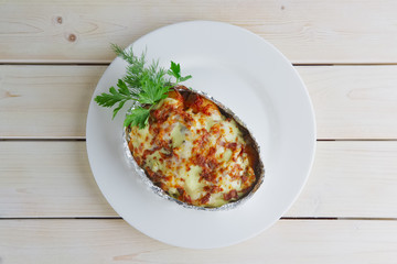 Meat baked in foil with vegetables and cheese