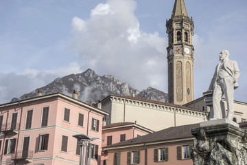 Fototapeta na wymiar Detail buildings historic center, monument mario cermentani and bell tower, campanile san nicolo,Lecco, Italy.