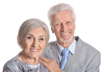 hugging senior couple on white background