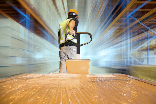 Blur Motion of Warehouse Worker Working with Hand Pallet Truck. Worker Loading Package Boxes at Storage Warehouse. Cargo Shipment Boxes. Warehouse Logistics.
