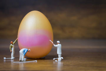 Miniature people :Painter is painting Easter-eggs