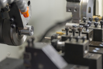 Fototapeta na wymiar The CNC lathe machine cutting the metal shaft parts