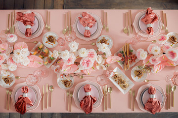 Festive table decor. In pastel pink colors with golden cutlery. With different natural colors...