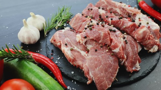 closeup view of fresh raw slices beef steak and organic vegetables. garlic healthy meal salt red pepper tasty meat herbs restaurant cooking cuisine ecology friendly product protein diet hot spices