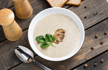 A bowl of mushroom soup cream on the table