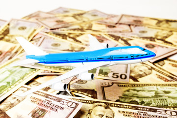 Blue white airplane on dollar and euro in cash close-up. Financial concept. tourist concept.