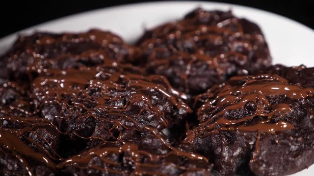 home cookies pour hot chocolate, close-up, black background, slow-motion shooting