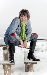Portrait of  happy, middle age woman on winter landscape