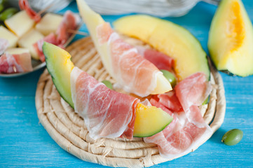 Cantaloupe melon, italian ham slices and olives