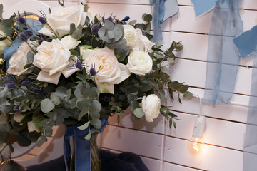 Delicate wedding decor with fresh roses on a white background. Side view, selective focus