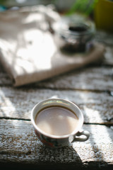 A cup of coffee in the morning sun.