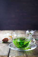 Peppermint tea in a glass cup on the table