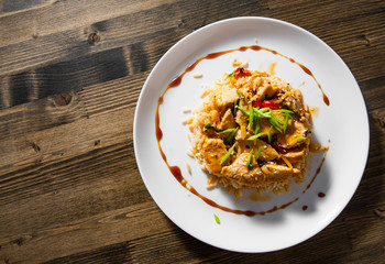 Chicken Breast with Rice in plate on a wooden background