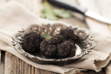 Black truffles on plate.